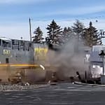 Driver escapes injury before semi is demolished by train in Versailles